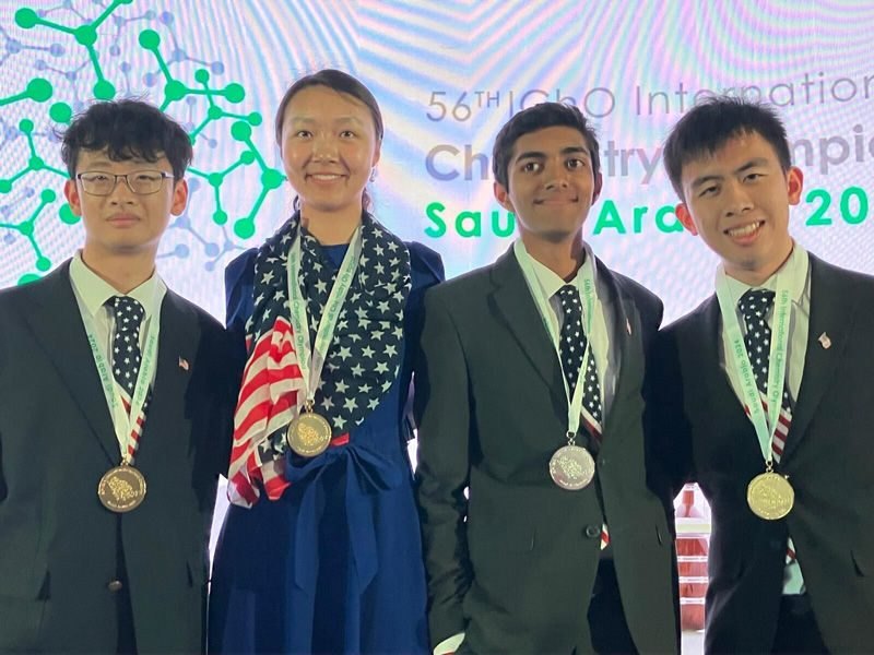 Team USA students with medals and the U.S. flag at the International Chemistry Olympiad